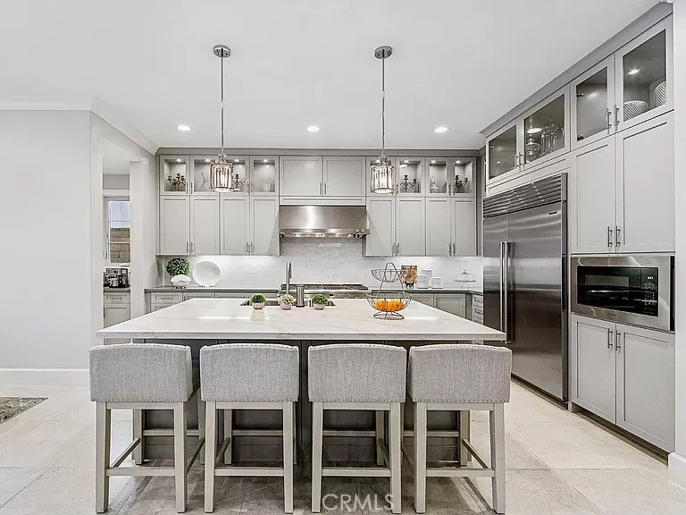 65 Rockinghorse Irvine, CA 92602 - Photo 13 of 45 a kitchen with kitchen island granite countertop a table and chairs in it