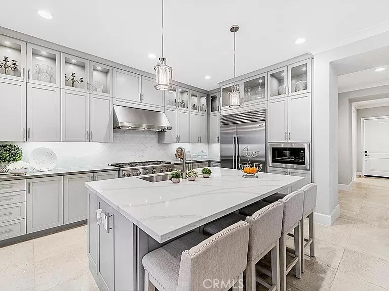 65 Rockinghorse Irvine, CA 92602 - Photo 14 of 45 a kitchen with a stove a kitchen island a table and chairs