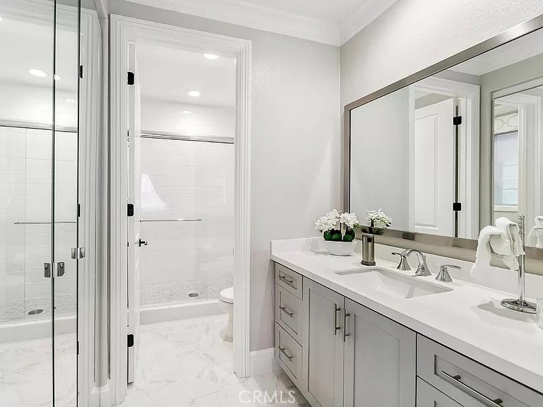 65 Rockinghorse Irvine, CA 92602 - Photo 17 of 45 a bathroom with a granite countertop sink two mirror and a shower