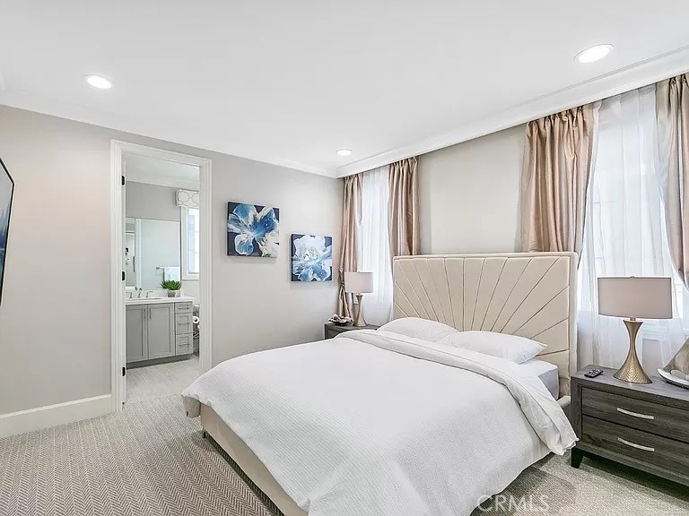 65 Rockinghorse Irvine, CA 92602 - Photo 31 of 45 a bedroom with a large bed and a wooden floor