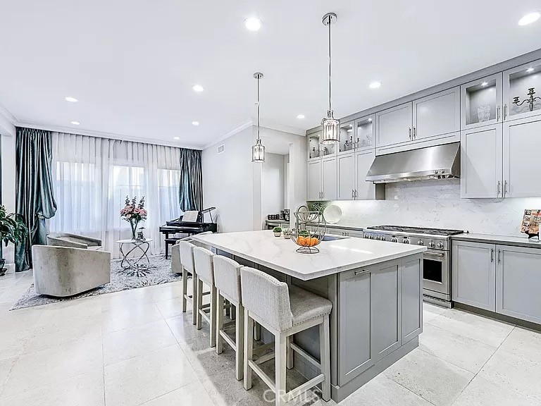 65 Rockinghorse Irvine, CA 92602 - Photo 10 of 45 a kitchen with a stove cabinets and a chandelier