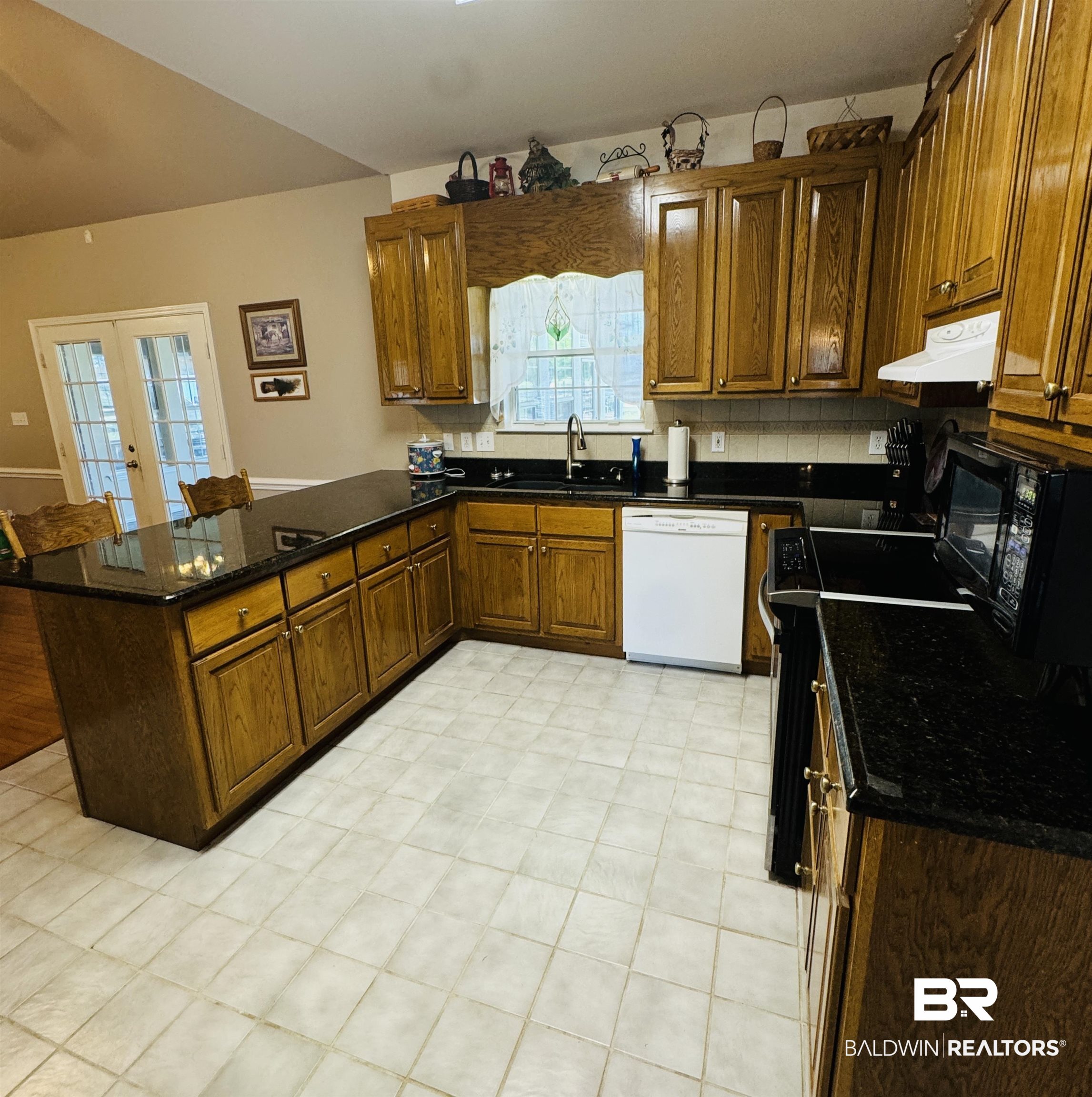 13795 White Road Silverhill, AL 36576 - Photo 29 of 99 Kitchen featuring a peninsula, black appliances, wood finish cabinetry, and dark stone counters