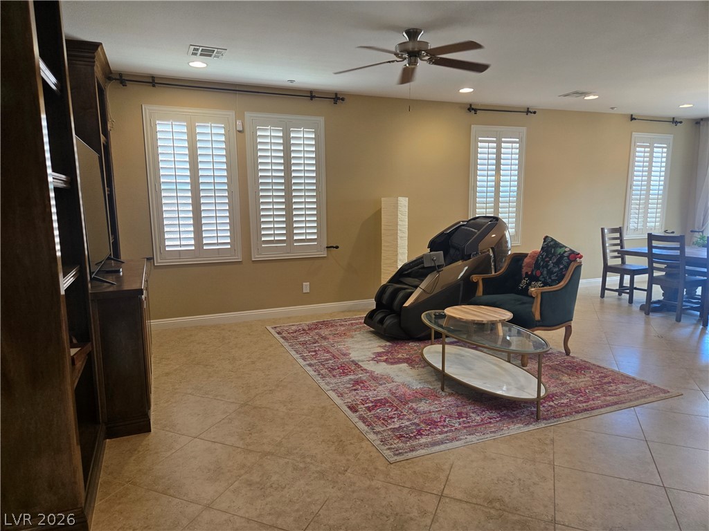3144 Whitfeild Avenue Henderson, NV 89044 - Photo 47 of 55 A versatile living space with ceramic tile flooring, plantation shutters, and a classic ceiling fan.