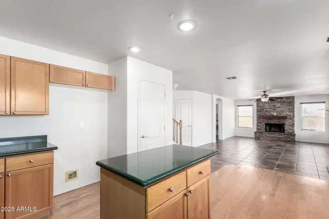 a kitchen with stainless steel appliances granite countertop a refrigerator a stove and a sink with cabinets