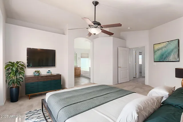 a bedroom with a bed and a flat screen tv