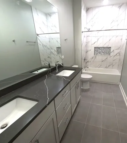 a bathroom with a sink a toilet and bathtub