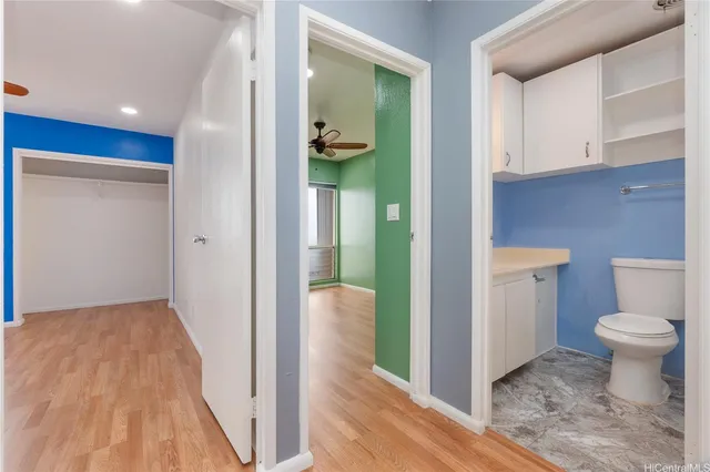 a bathroom with a toilet and a view of bathroom