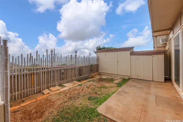a view of a backyard with a fence