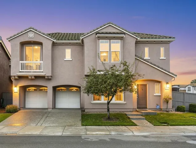 a front view of a house with a yard and garage