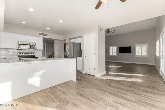 a view of kitchen with microwave and refrigerator