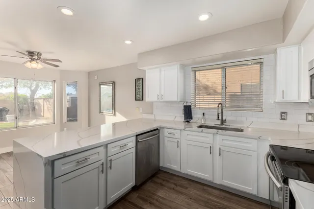 a kitchen with a sink a window and cabinets