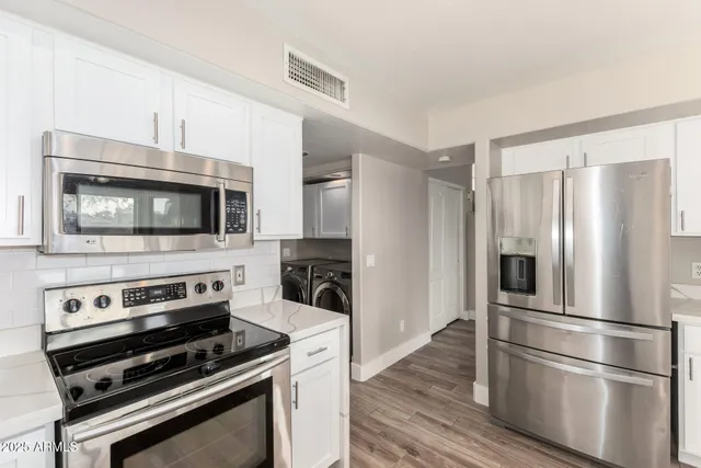a kitchen with wooden cabinets and stainless steel appliances