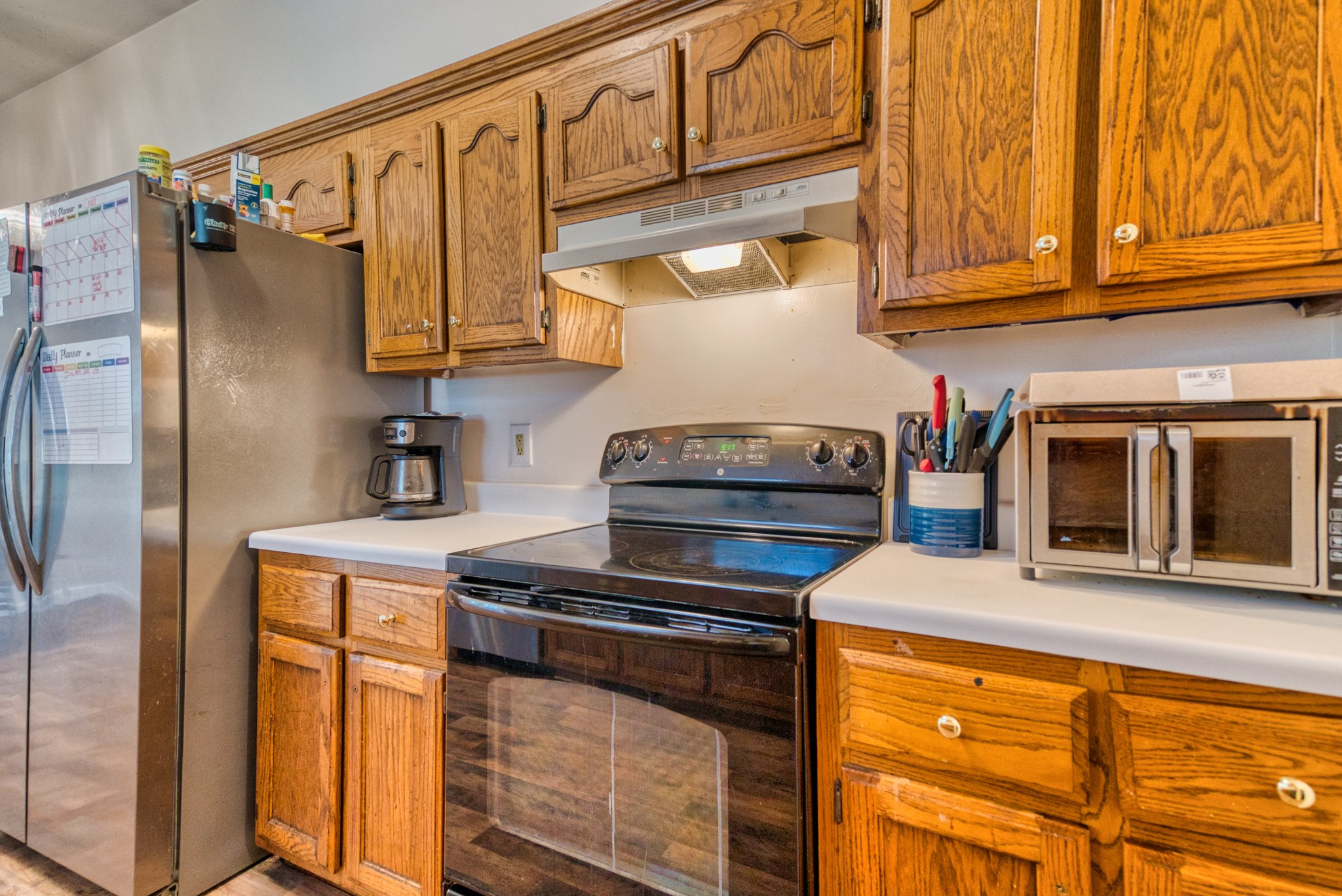 190 Rose Street Greenbrier, TN 37073 - Photo 23 of 32 a kitchen with stainless steel appliances granite countertop a stove and a refrigerator
