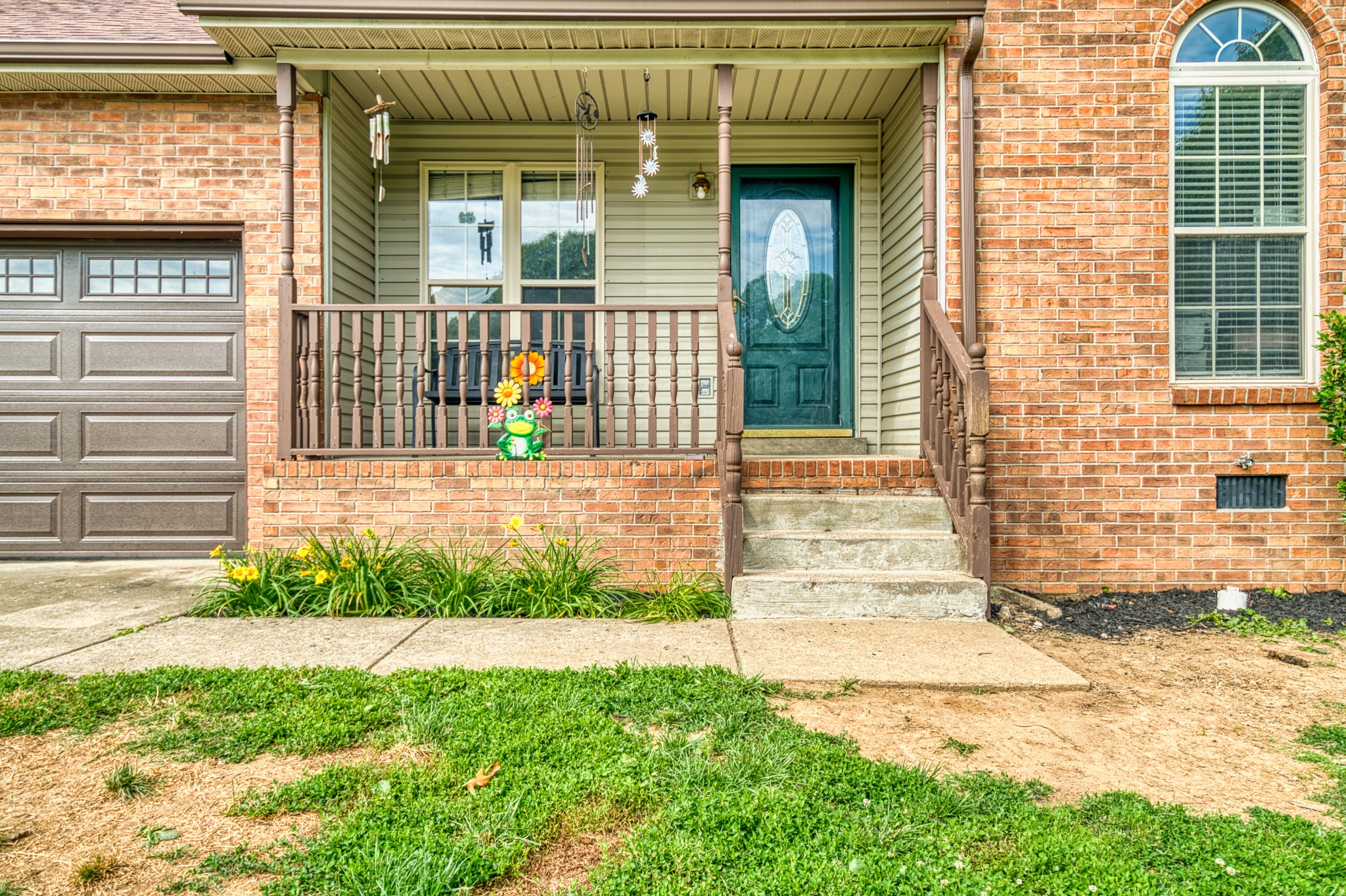190 Rose Street Greenbrier, TN 37073 - Photo 4 of 32 a front view of a house with a garden and plants