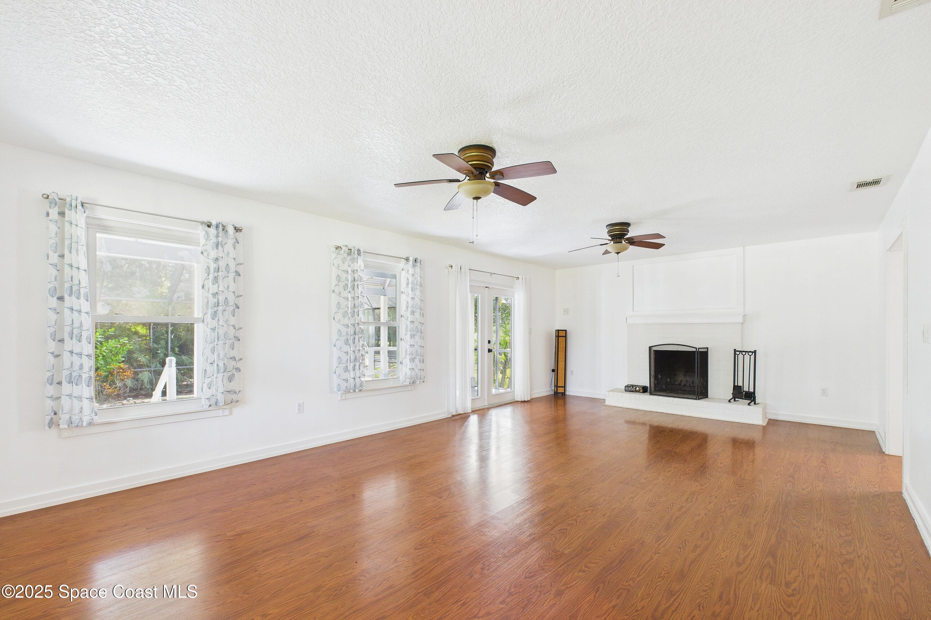 3435 Huggins Drive Malabar, FL 32950 - Photo 11 of 63 wooden floor in an empty room with a window