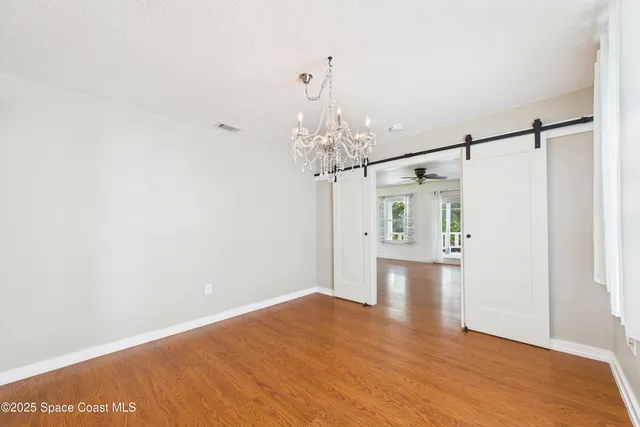 a kitchen with stainless steel appliances granite countertop wooden cabinets a stove top oven a sink and dishwasher with wooden floor