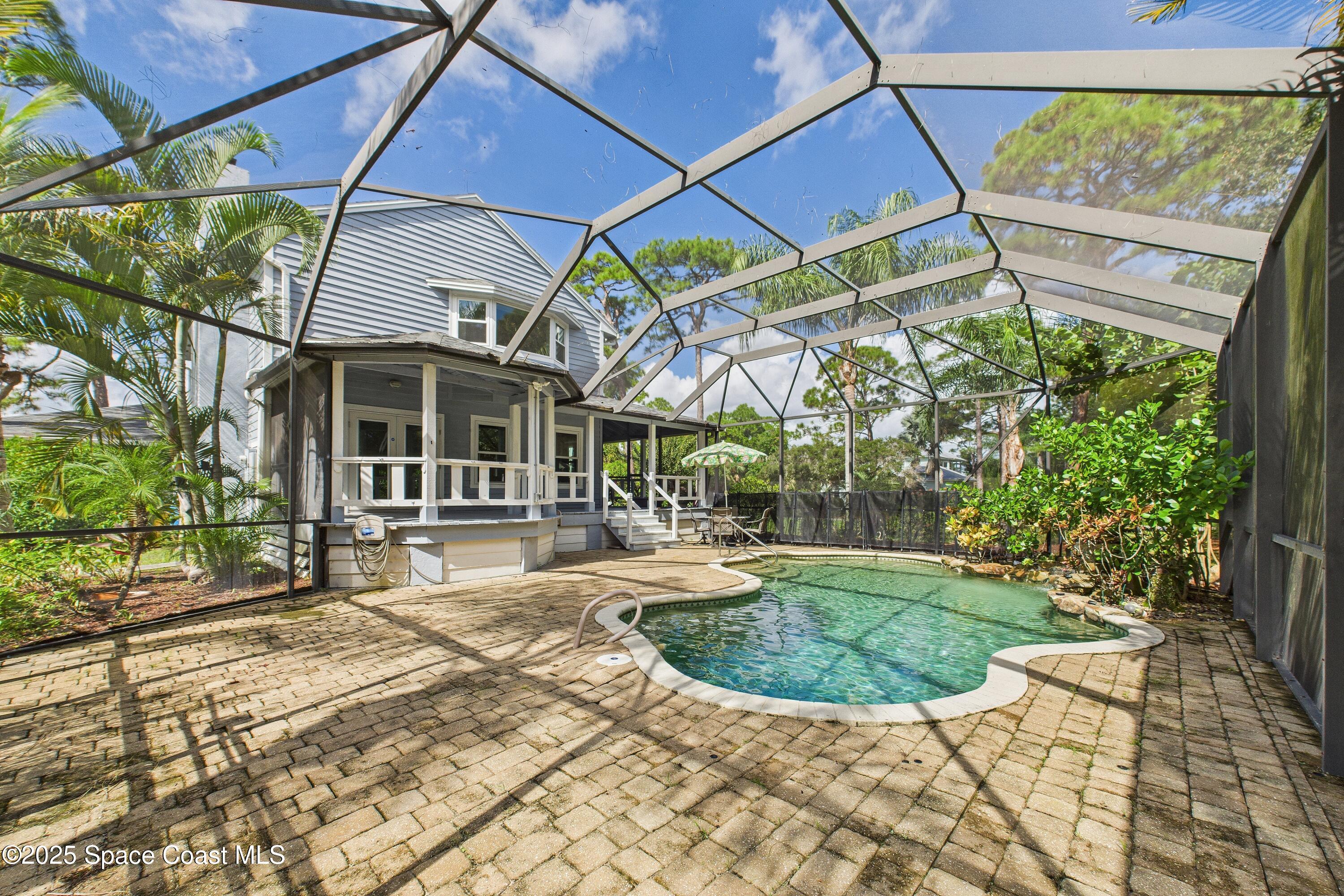 3435 Huggins Drive Malabar, FL 32950 - Photo 2 of 63 a view of a patio with table and chairs under an umbrella