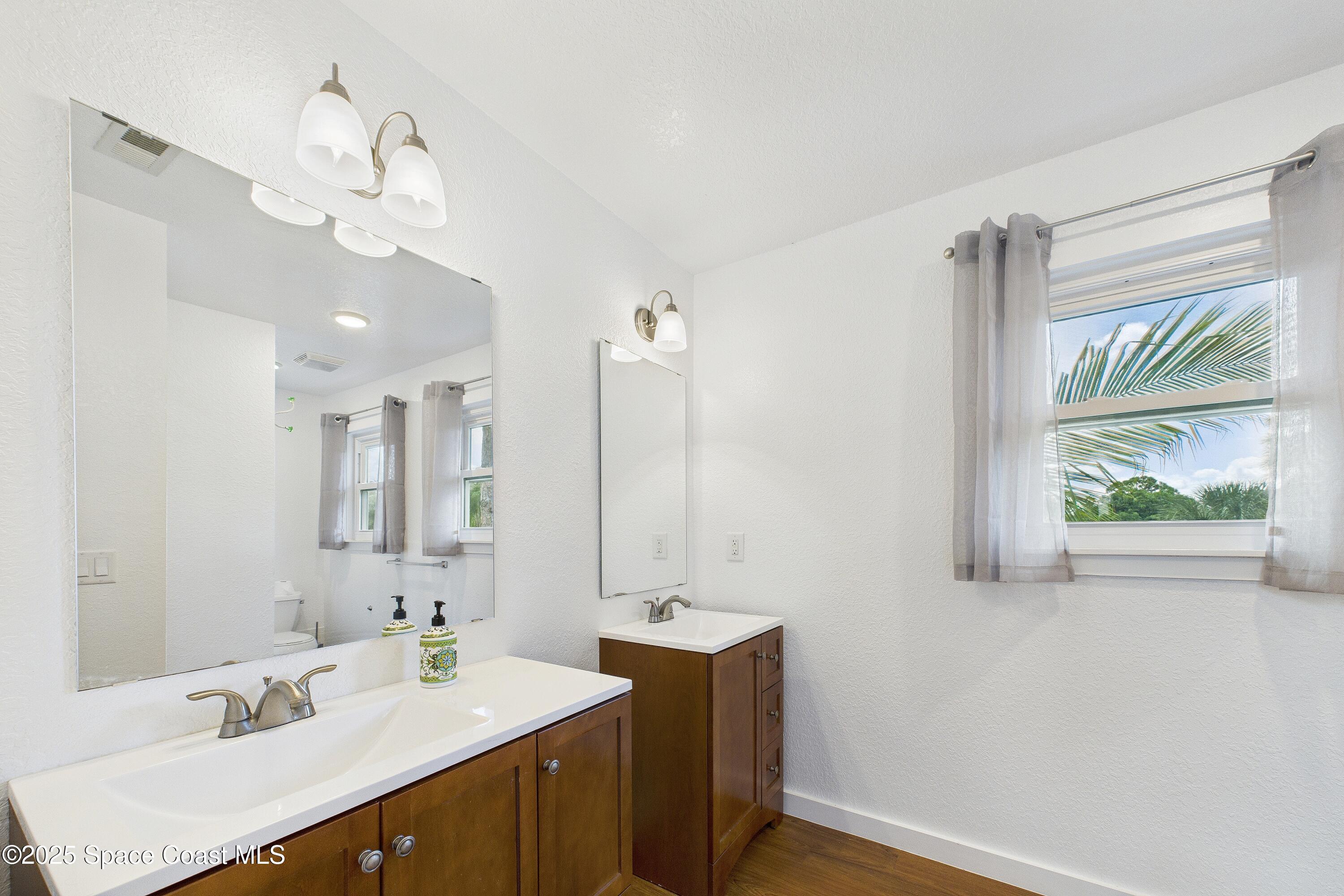 3435 Huggins Drive Malabar, FL 32950 - Photo 41 of 63 a bathroom with a sink a vanity and a mirror
