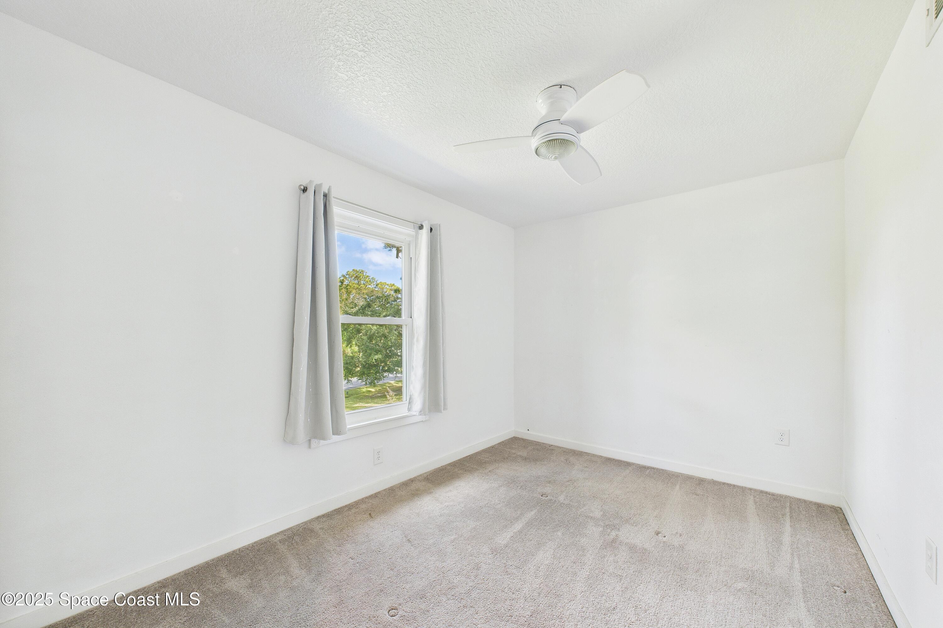 3435 Huggins Drive Malabar, FL 32950 - Photo 43 of 63 an empty room with a window and a fan