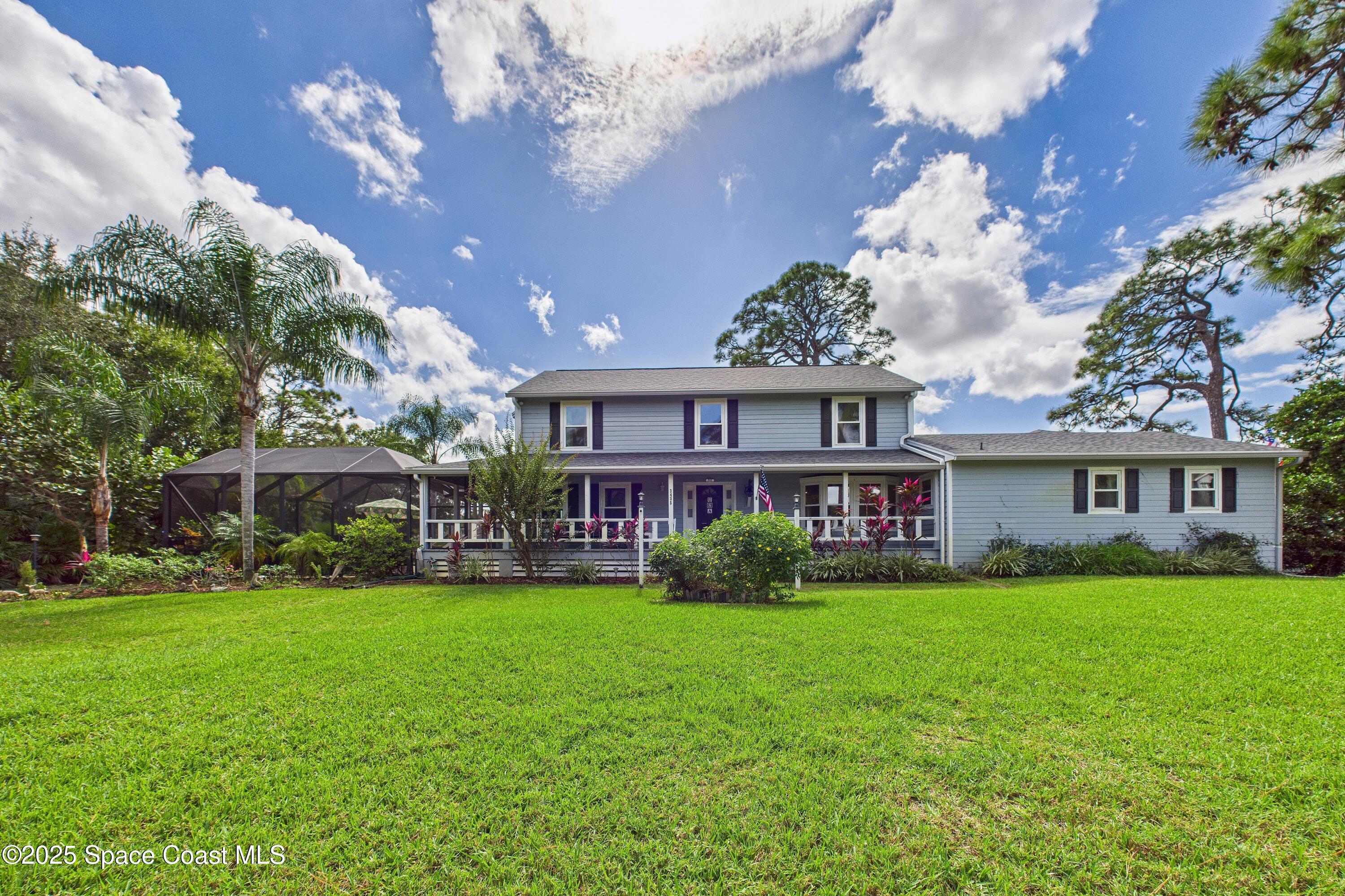 3435 Huggins Drive Malabar, FL 32950 - Photo 61 of 63 a view of a house next to a big yard and large trees