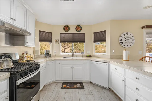 a living room with furniture and a refrigerator