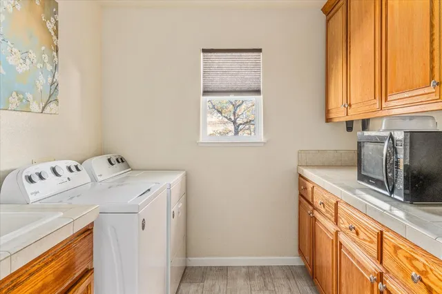 a view of a patio with table and chairs a barbeque with wooden floor and fence