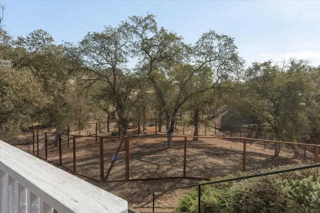 a view of a house with a yard from a balcony