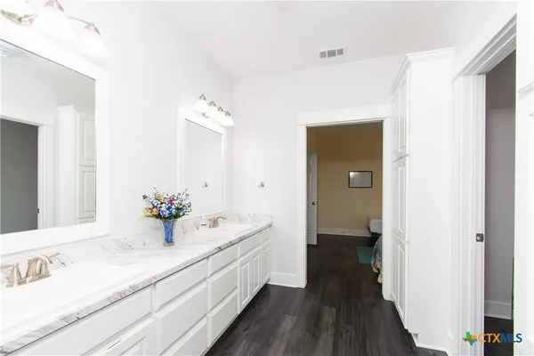a view of a room with wooden floor