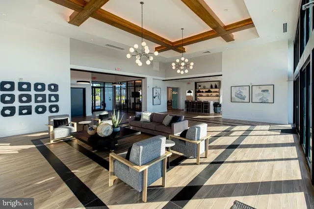 a living room with furniture and chandelier