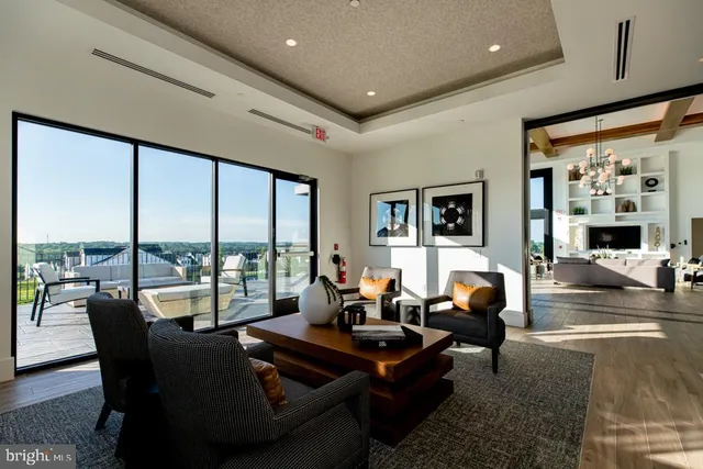 a living room with furniture tv and large window