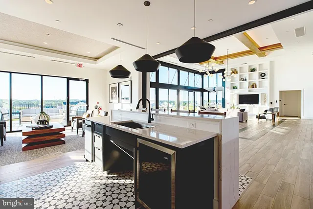 a kitchen with a table chairs and flat screen tv