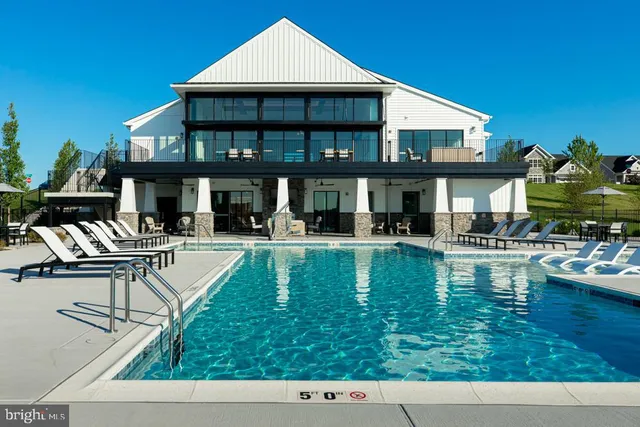 a swimming pool view with a outdoor seating