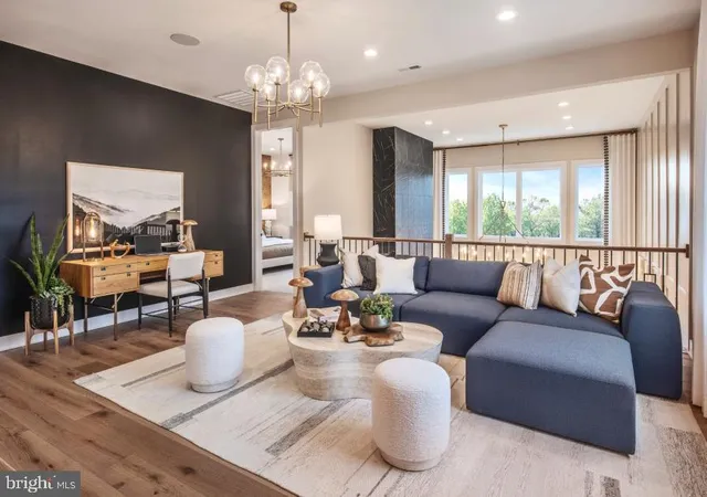 a living room with furniture chandelier and a large window