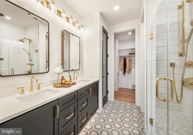 a bathroom with a double vanity sink mirror and shower