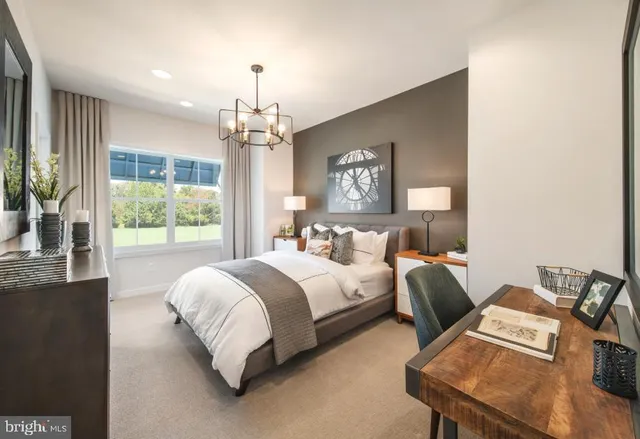 a spacious bedroom with a bed and a chandelier