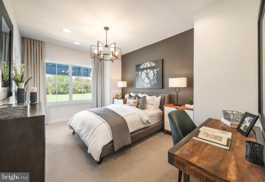 508 Trifecta Road, Unit 275 Downingtown, PA 19335 - Photo 40 of 44 a spacious bedroom with a bed and a chandelier
