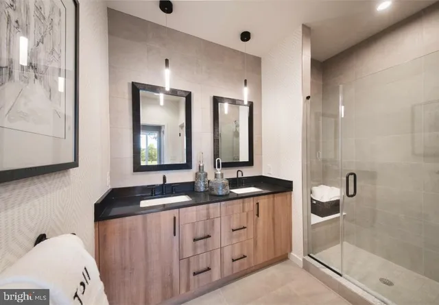 a bathroom with a double vanity sink and a mirror