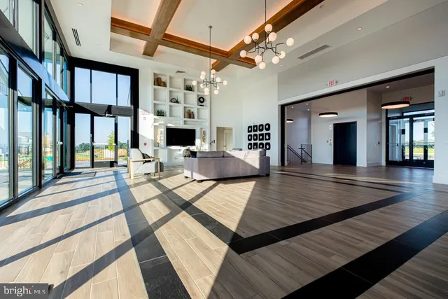 a view of a living room and dining room with wooden floor