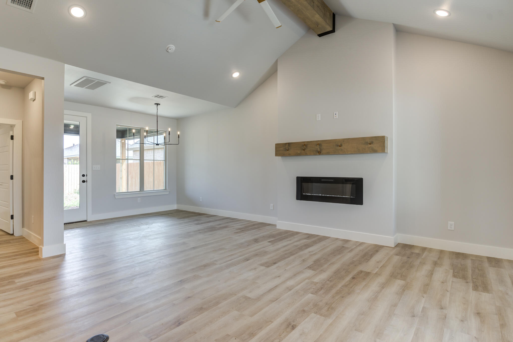 6914 13th Street Lubbock, TX 79416 - Photo 11 of 49 an empty room with wooden floor and windows