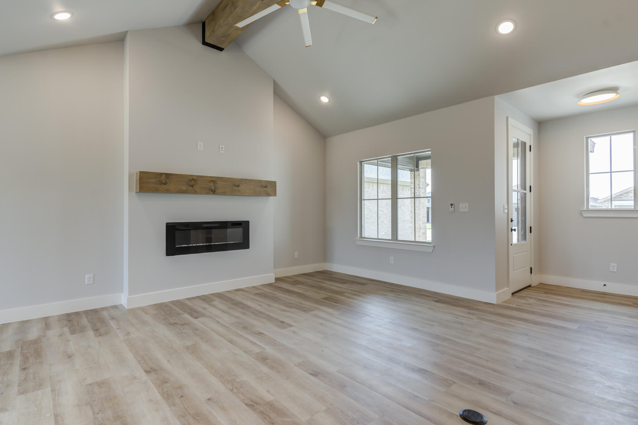 6914 13th Street Lubbock, TX 79416 - Photo 14 of 49 an empty room with windows and fireplace