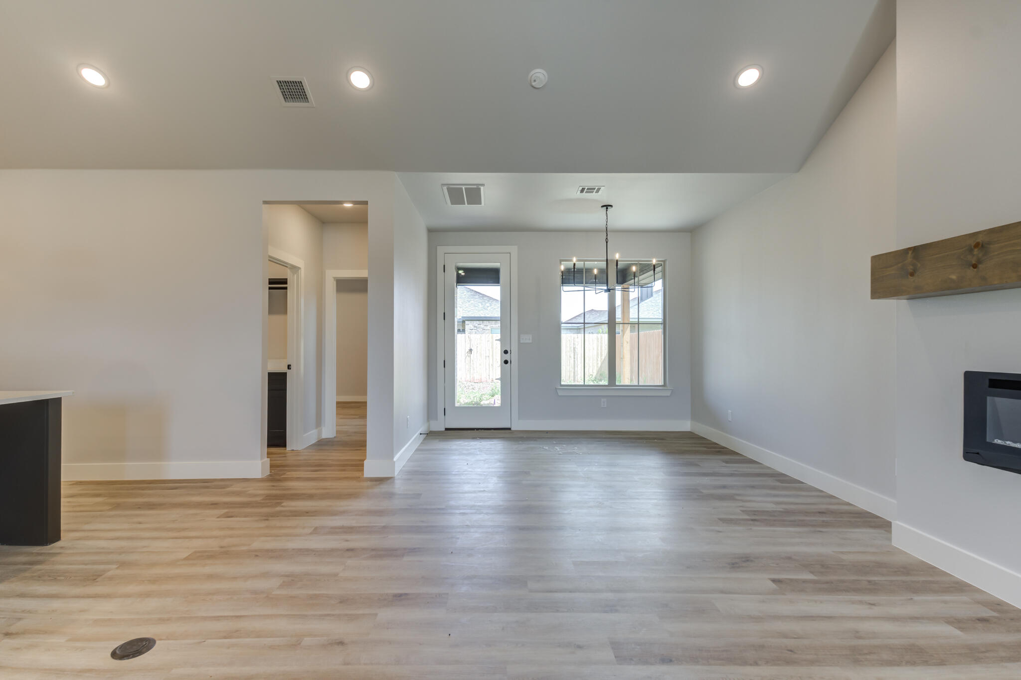 6914 13th Street Lubbock, TX 79416 - Photo 20 of 49 a view of an empty room with wooden floor and a window