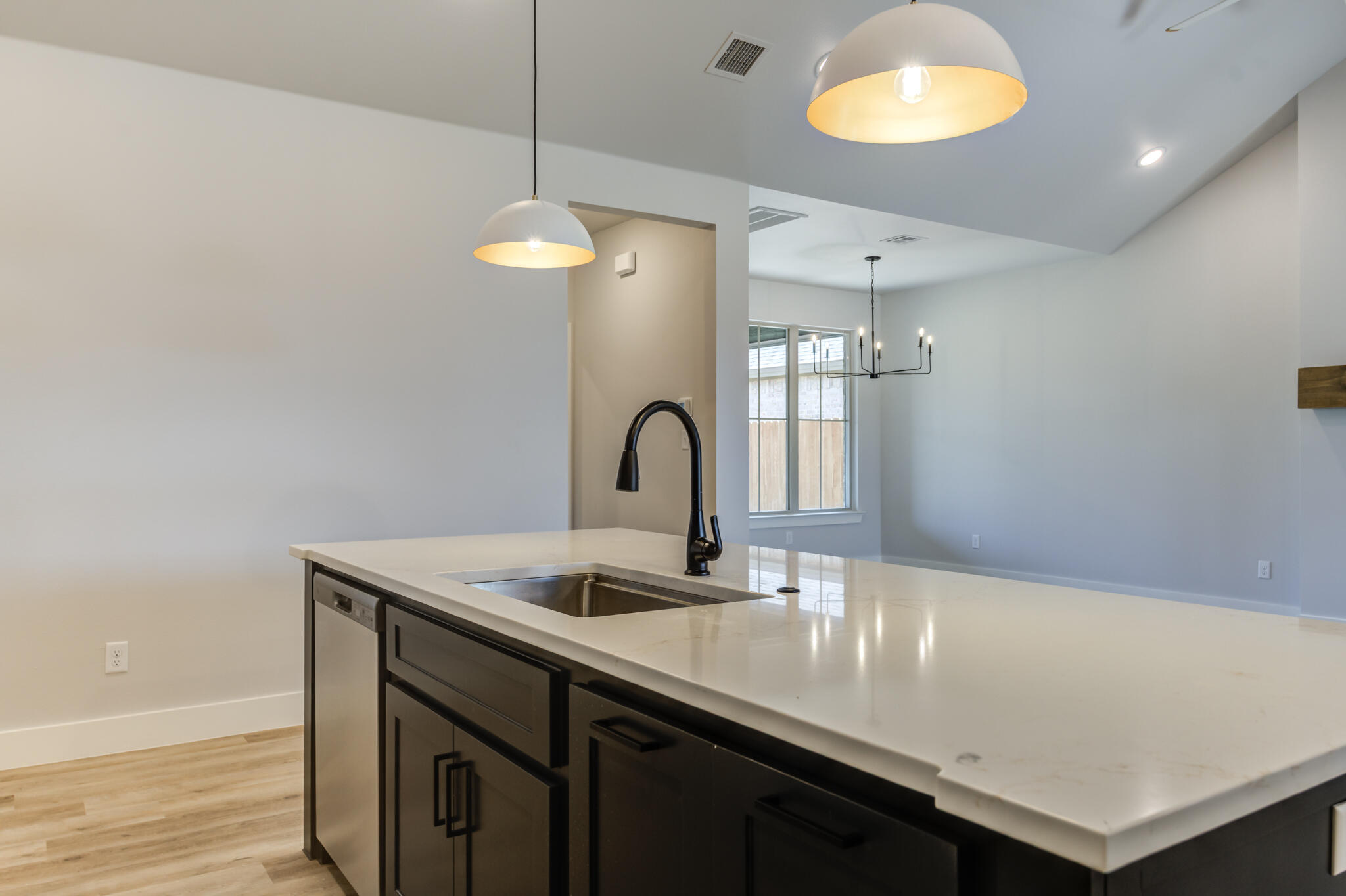 6914 13th Street Lubbock, TX 79416 - Photo 24 of 49 a kitchen with a sink and a refrigerator