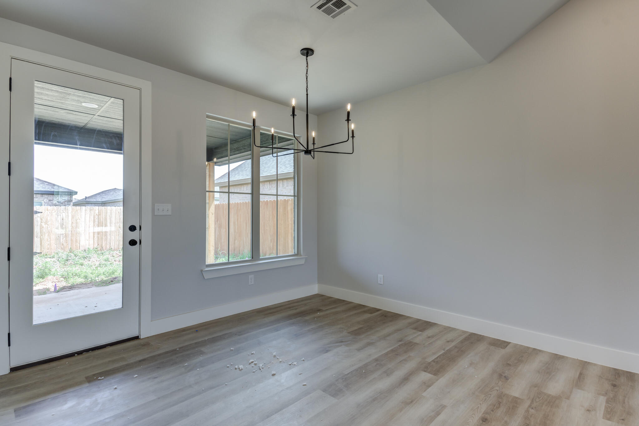 6914 13th Street Lubbock, TX 79416 - Photo 30 of 49 a view of an empty room with wooden floor and a window
