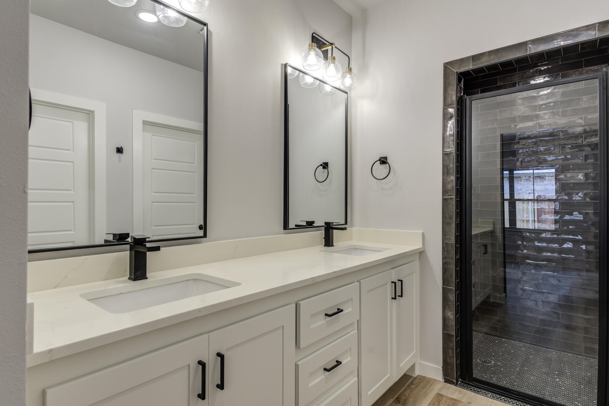 6914 13th Street Lubbock, TX 79416 - Photo 38 of 49 a bathroom with double sink and two mirror