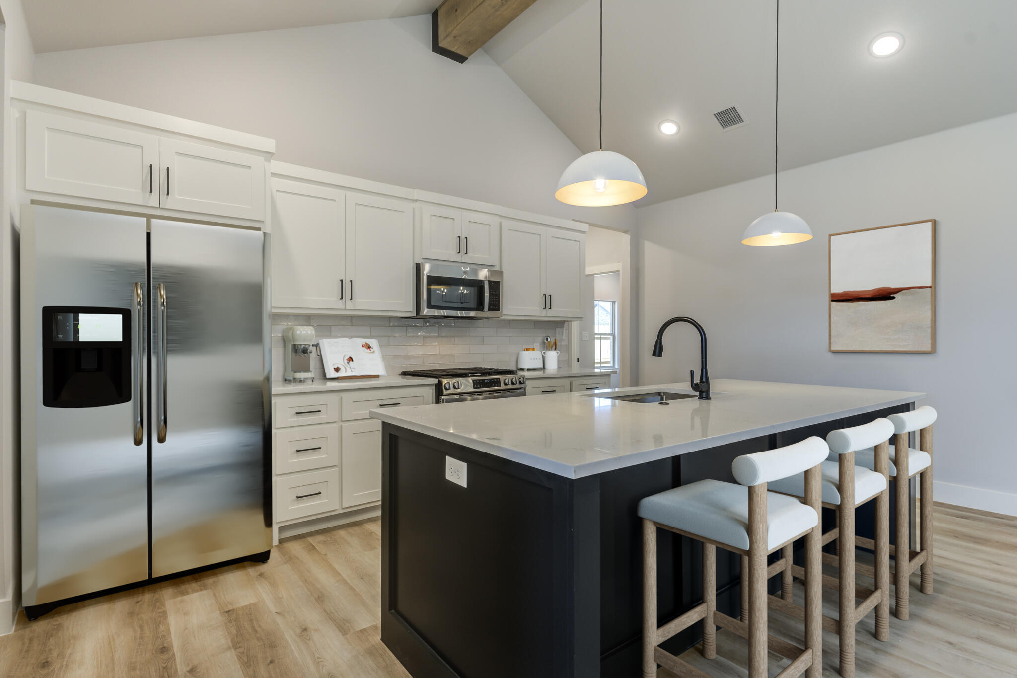 6914 13th Street Lubbock, TX 79416 - Photo 4 of 49 a kitchen with a sink stainless steel appliances and white cabinets