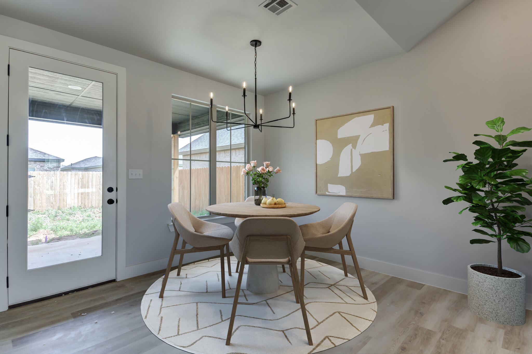 6914 13th Street Lubbock, TX 79416 - Photo 5 of 49 a dining room with chandelier and wooden floor
