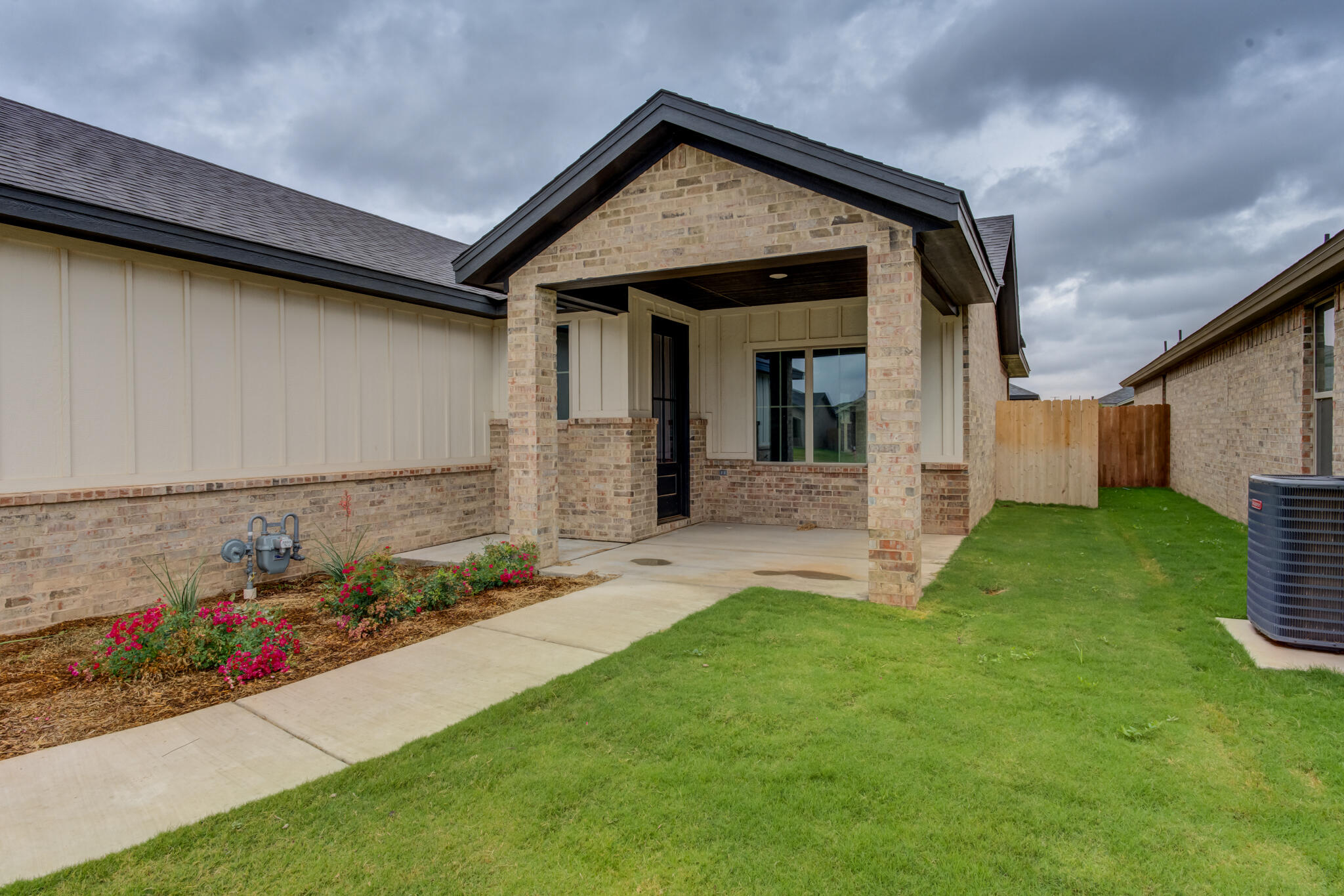 6914 13th Street Lubbock, TX 79416 - Photo 7 of 49 a front view of a house with a yard and garage
