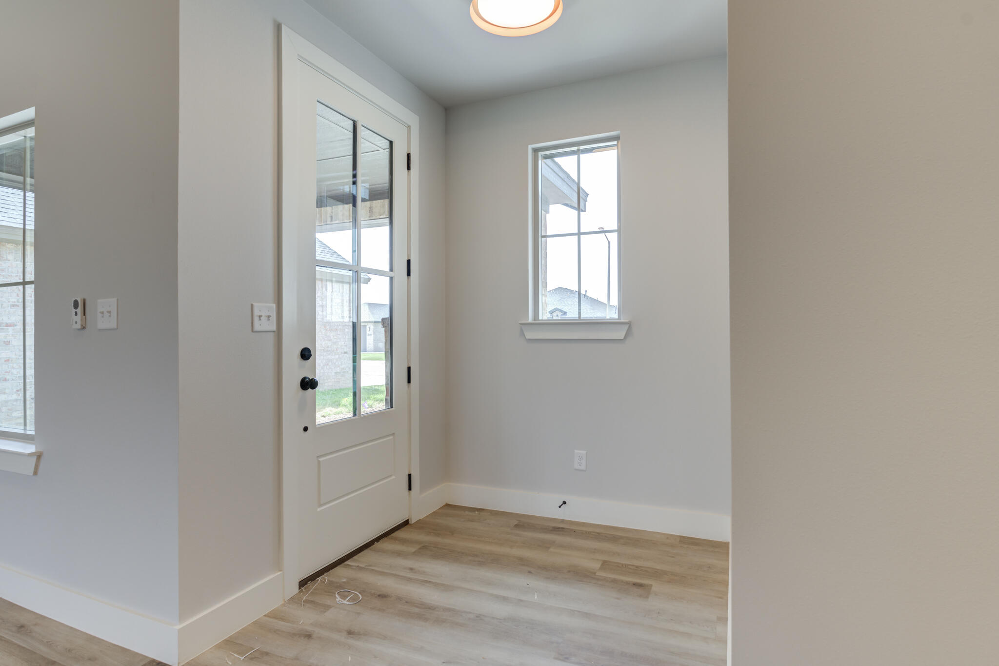 6914 13th Street Lubbock, TX 79416 - Photo 9 of 49 an empty room with wooden floor and windows