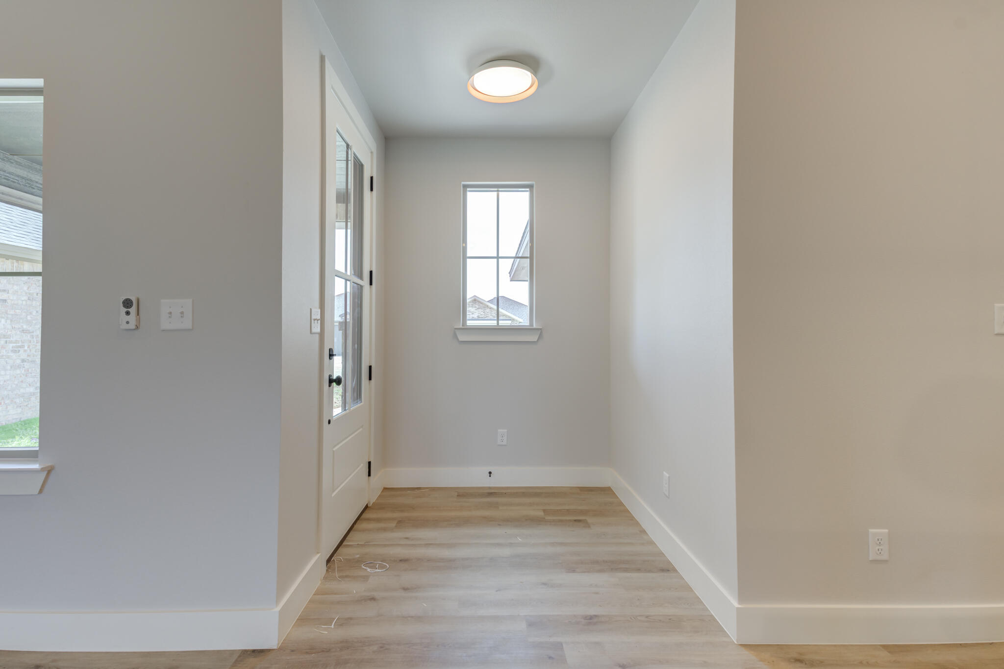 6914 13th Street Lubbock, TX 79416 - Photo 10 of 49 a view of an empty room with wooden floor and window