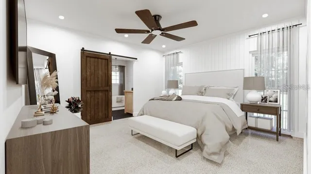 a bedroom with a bed and a large mirror